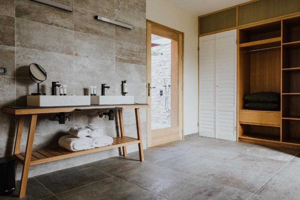 Salle de bains, double vasque sur console bois et douche à l'italienne · © Sarana Hôtel & Spa